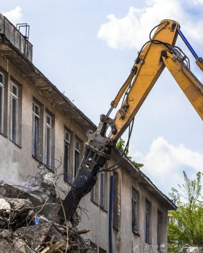 demolition of a building with a hydraulic excavator